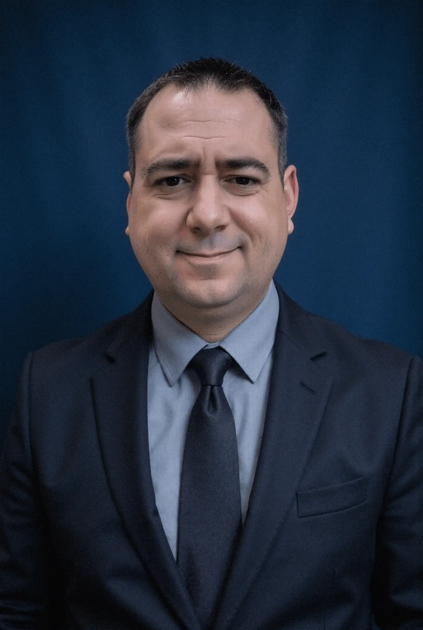Man in suit with blue background.