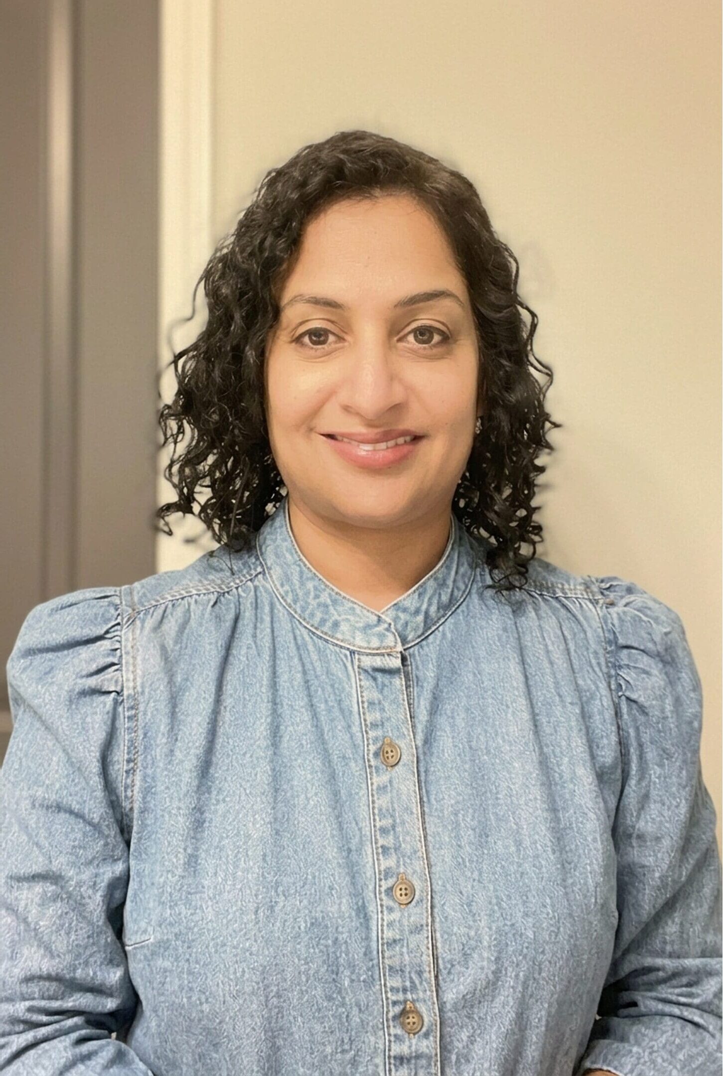 photo of smiling woman in blue blouse